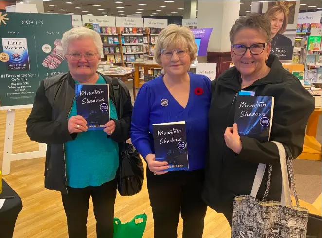 laurie and two ladies booksigning copy